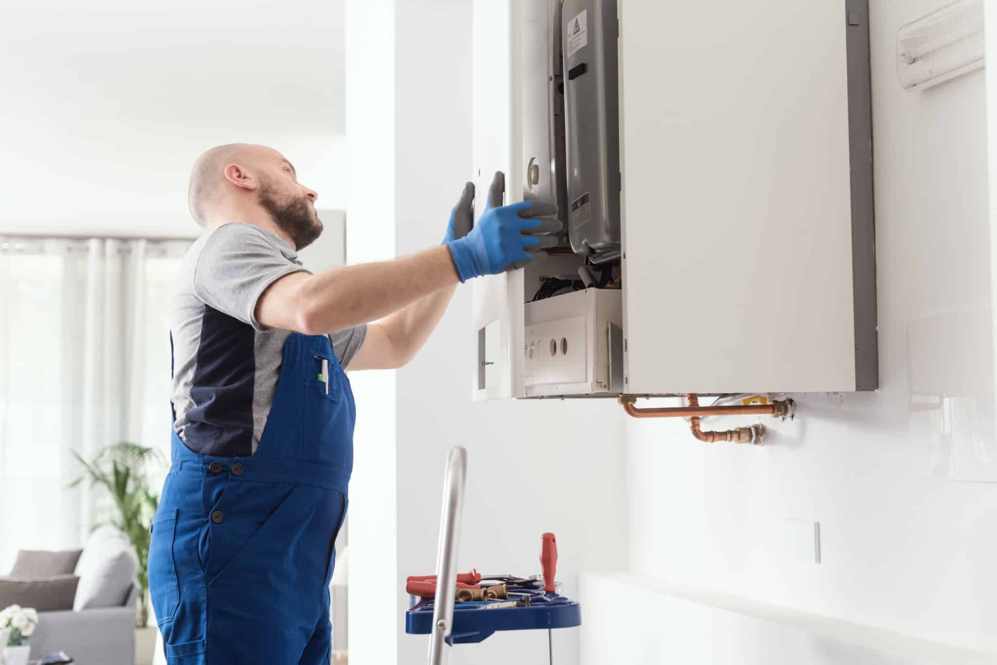 Professional engineer doing a boiler inspection at home